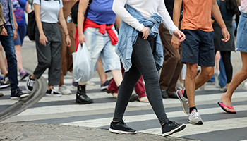 A collective of pedestrians walking on a street